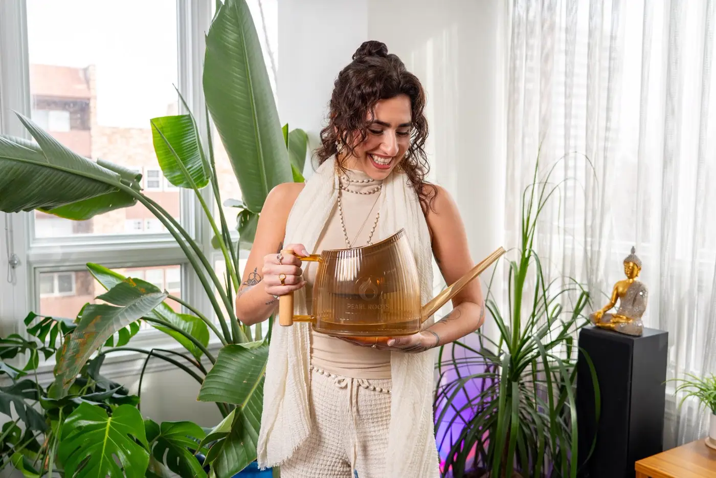 Plant mom caring for houseplants with the Pearl Roots watering can