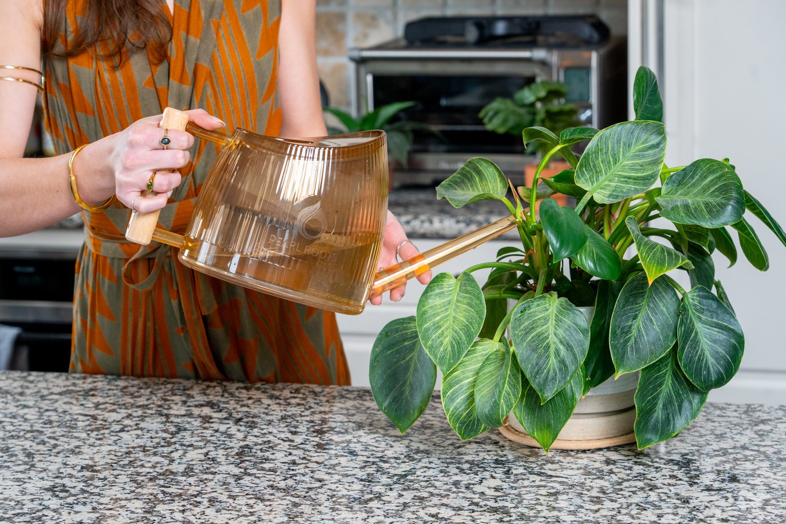 Filling the Pearl Roots watering can from the tap